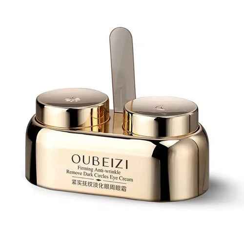 Gold eye cream jar with applicator on a white background, featuring the brand 'OUBEIZI'.