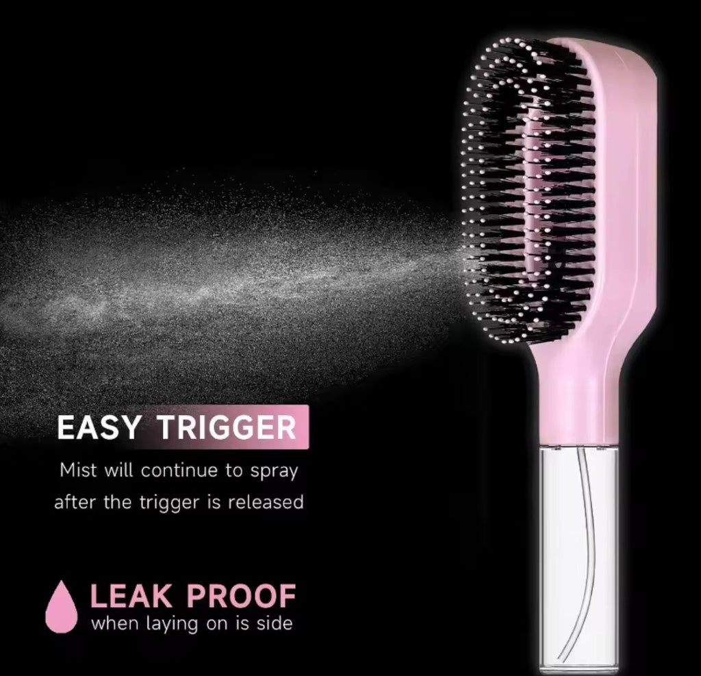 Pink and white electric hairbrush with a misting feature, shown on a black background with text highlighting 'EASY TRIGGER' and 'LEAK PROOF'.