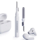 White earbud cleaning tool with charging case on a white background